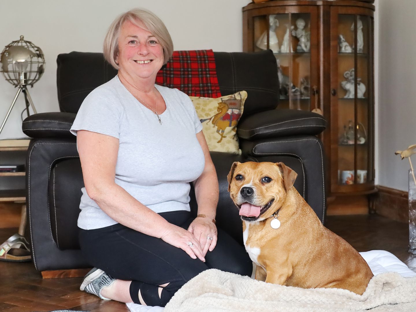 Foster carer Sue sitting with American Bulldog Major