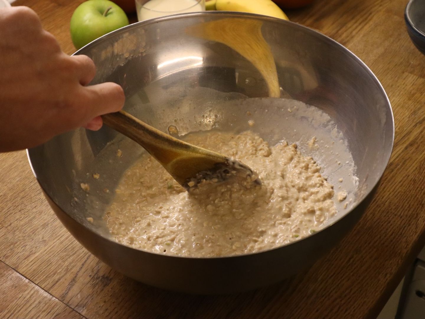 apple spiced cupcakes batter in a bowl with a wooden spoon